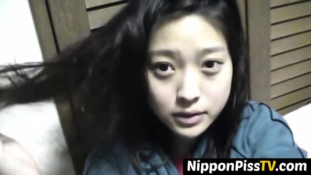 Delightful Japanese chick sits on the latrine and pees in a cup