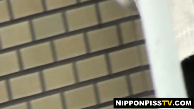 Peeping lens films girls urinating in open public toilets