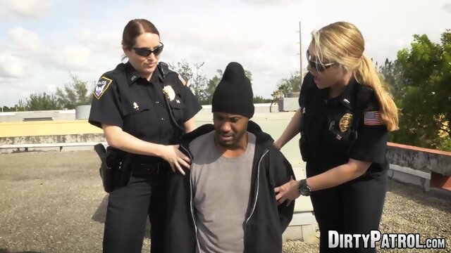 Big ass uniformed babes fuck a criminal on the rooftop