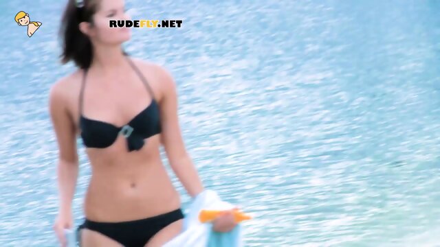 Playful young nudist with nice body is having fun the beach